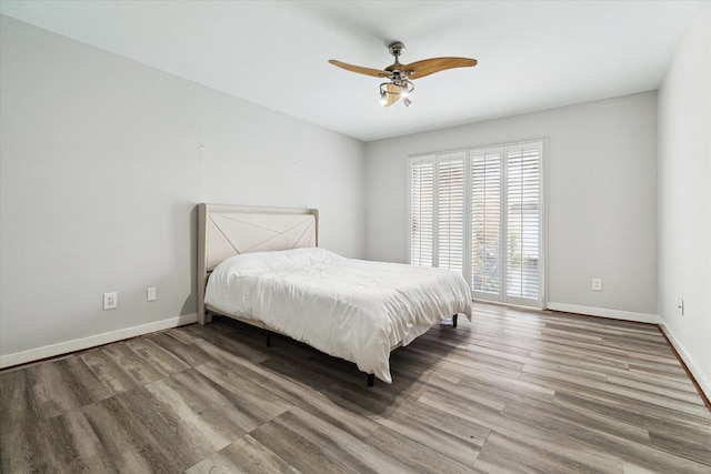 bedroom with ceiling fan and wood-type flooring