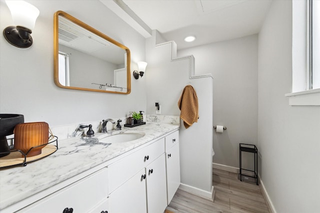 bathroom with hardwood / wood-style floors and vanity