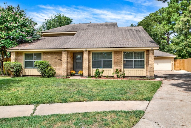 view of front of home featuring a front yard and a garage