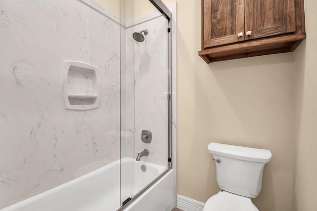 bathroom with toilet and combined bath / shower with glass door