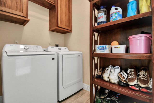 laundry room featuring cabinets and washing machine and clothes dryer