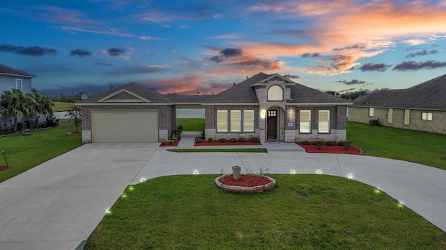 view of front of house with a lawn and a garage