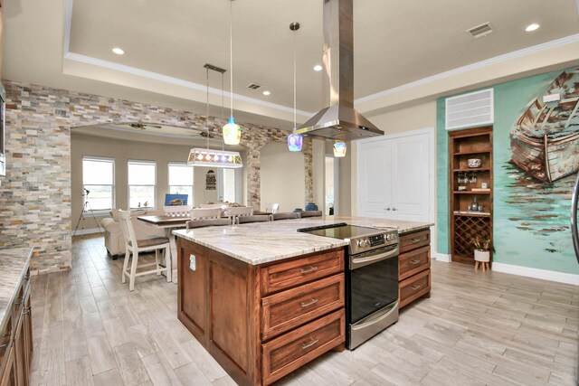 kitchen featuring light stone countertops, hanging light fixtures, island exhaust hood, a spacious island, and stainless steel electric range