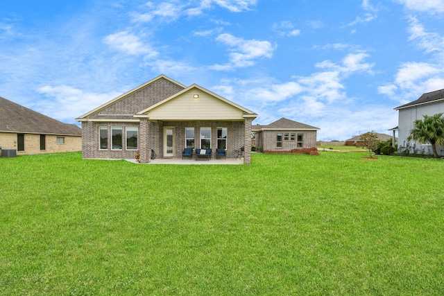 rear view of house featuring a lawn, central AC unit, and a patio area