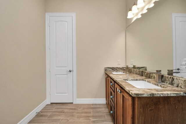 bathroom with vanity and wood-type flooring