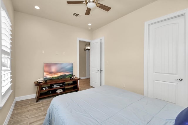 bedroom featuring multiple windows and ceiling fan