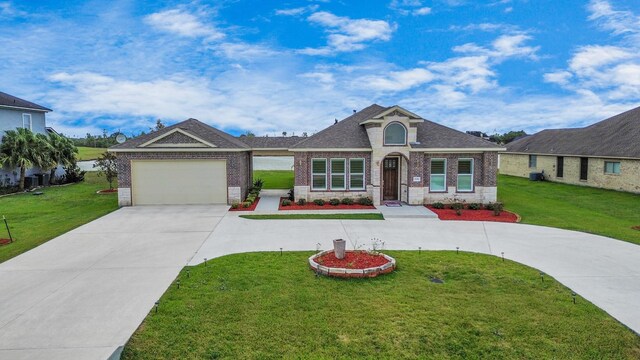 view of front of property with a front yard and a garage