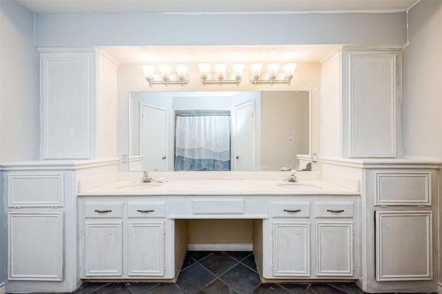 bathroom with tile patterned floors, a sink, and double vanity