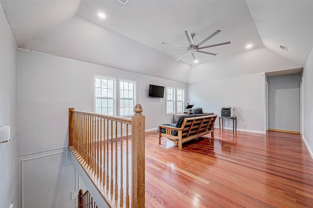 sitting room with wood-type flooring, ceiling fan, and lofted ceiling