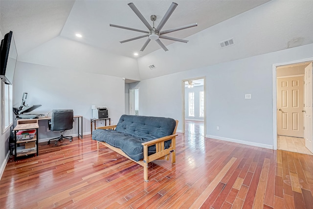 sitting room with ceiling fan, light hardwood / wood-style floors, and lofted ceiling