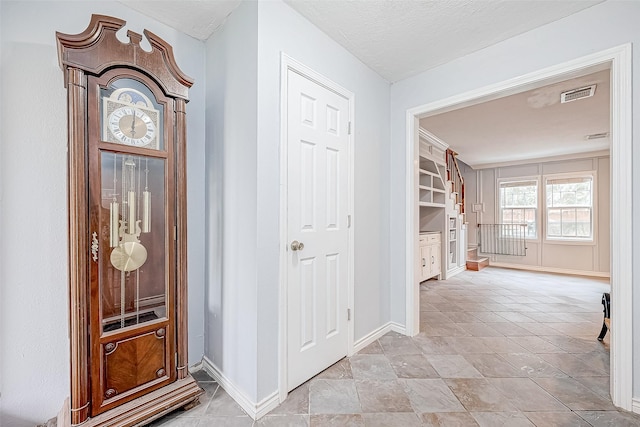 hallway featuring a textured ceiling