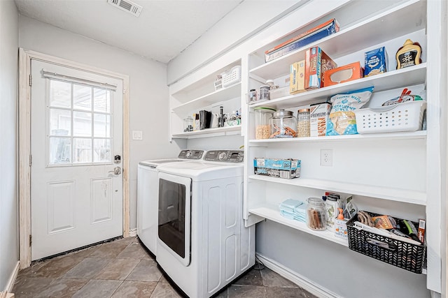 laundry room featuring laundry area, baseboards, visible vents, and separate washer and dryer