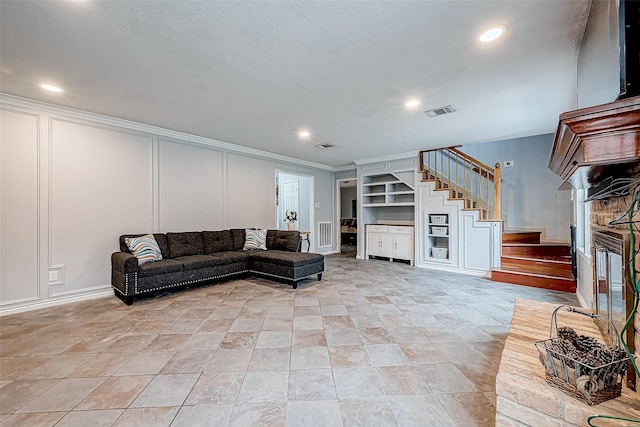 living room featuring built in shelves and ornamental molding