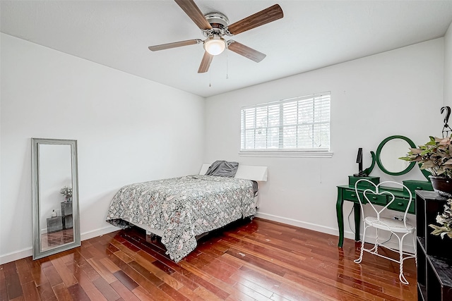 bedroom with wood finished floors, a ceiling fan, and baseboards