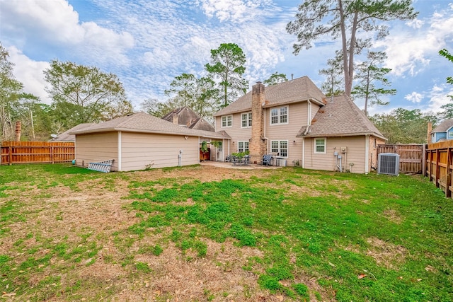 back of property featuring central AC, a patio area, and a yard