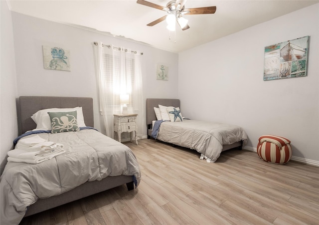 bedroom featuring light hardwood / wood-style flooring and ceiling fan