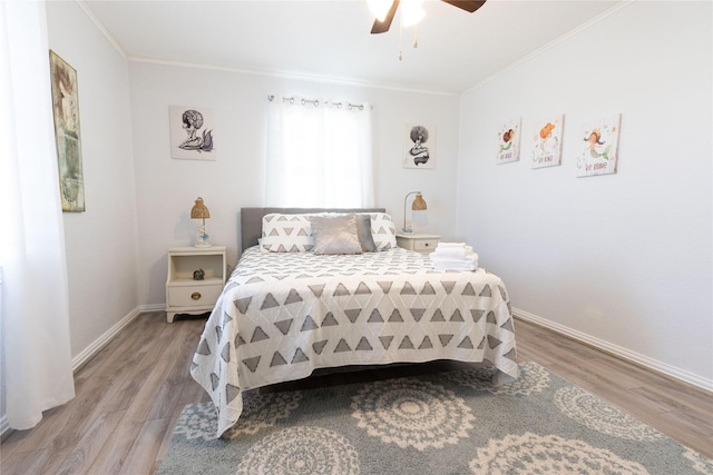 bedroom featuring ornamental molding, ceiling fan, and wood-type flooring