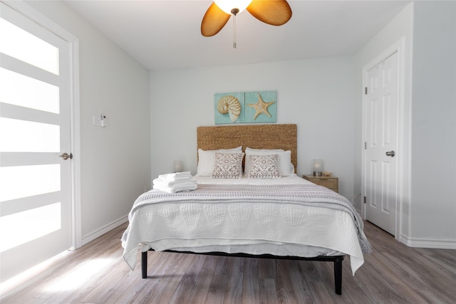 bedroom with hardwood / wood-style flooring and ceiling fan