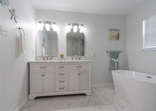 bathroom featuring vanity and a tub