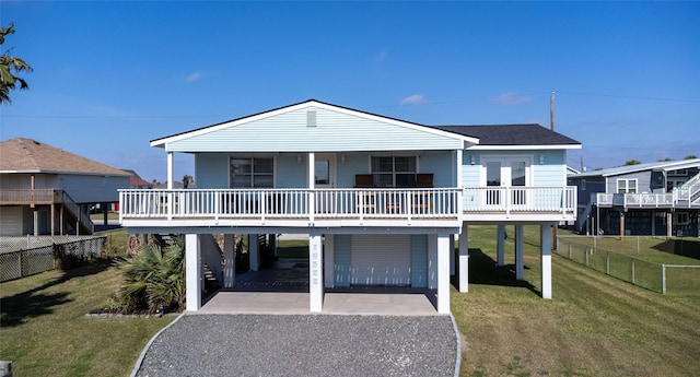 beach home with a front lawn, a carport, and a porch