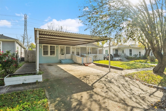 back of property with a carport and a yard