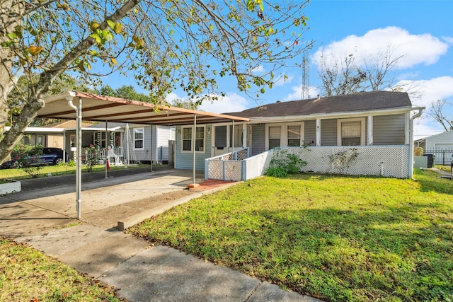 single story home featuring a carport, a porch, and a front lawn