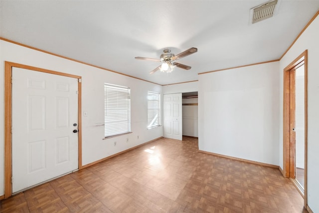 entryway featuring ceiling fan, crown molding, and light parquet flooring