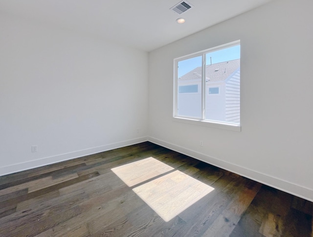 unfurnished room with dark hardwood / wood-style flooring