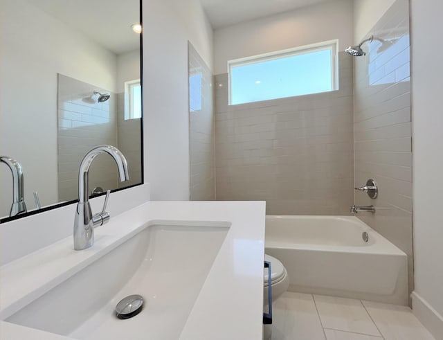 full bathroom featuring vanity, tile patterned flooring, tiled shower / bath, and toilet