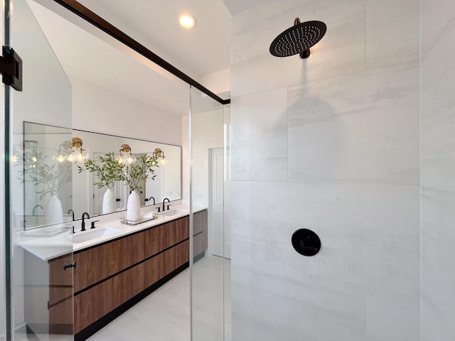 bathroom featuring a tile shower, tile patterned floors, and vanity