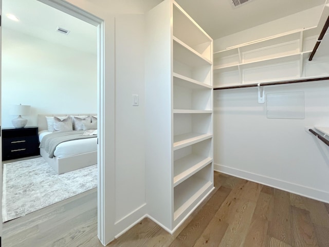 walk in closet featuring hardwood / wood-style floors