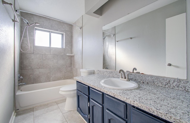 full bathroom with vanity, tiled shower / bath combo, tile patterned floors, and toilet