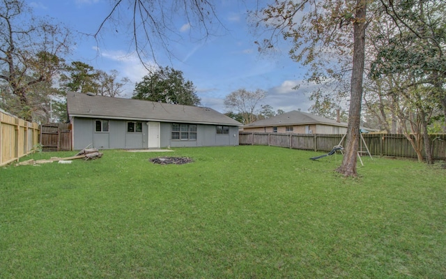 rear view of property featuring a yard