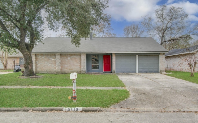 single story home with a garage and a front lawn