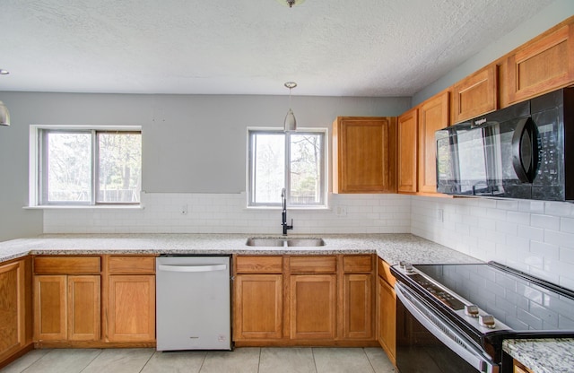 kitchen featuring decorative backsplash, a healthy amount of sunlight, sink, and stainless steel appliances