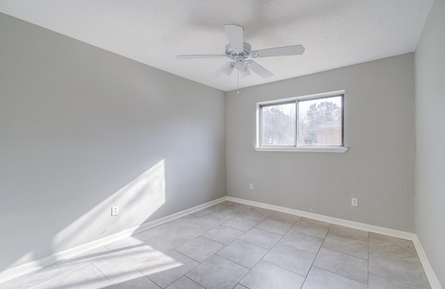 tiled empty room with ceiling fan