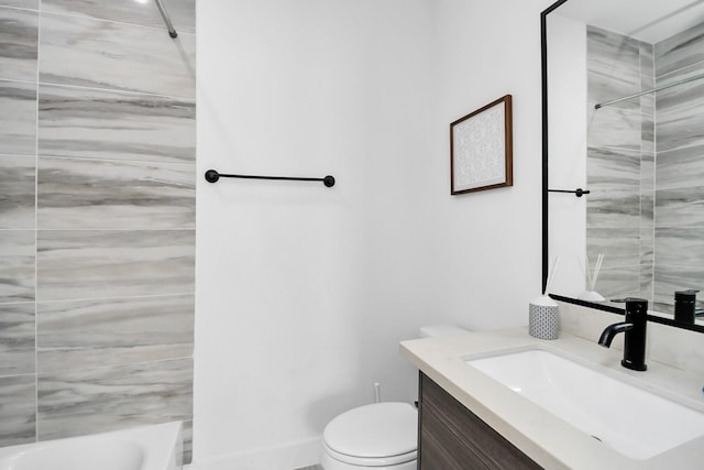 full bathroom with tiled shower / bath, vanity, and toilet