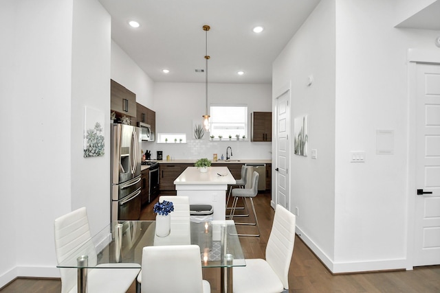 dining space with hardwood / wood-style floors and sink