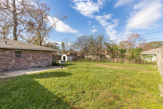 view of yard featuring a patio and a storage shed