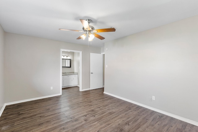 spare room with dark hardwood / wood-style flooring and ceiling fan