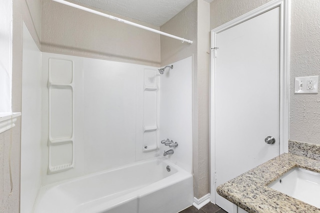 bathroom featuring washtub / shower combination and vanity