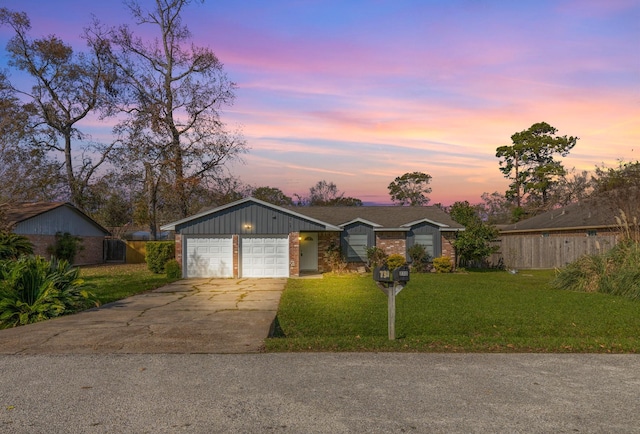 ranch-style home with a lawn and a garage