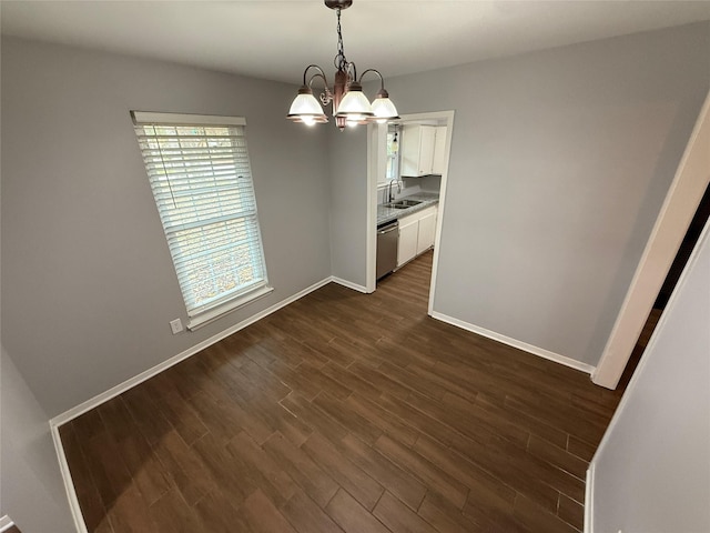 unfurnished dining area with dark hardwood / wood-style flooring, sink, and an inviting chandelier