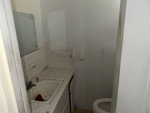 bathroom featuring vanity and toilet