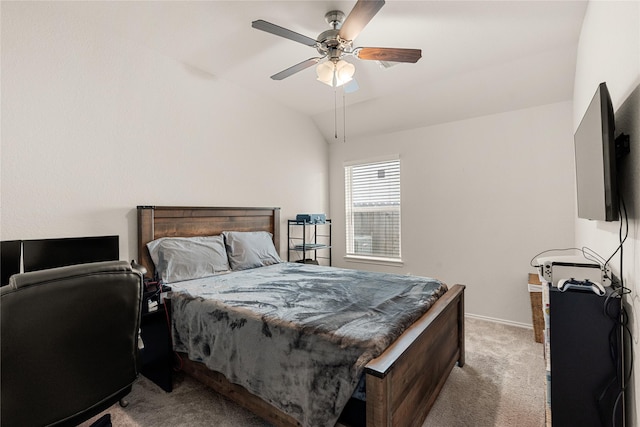 bedroom with ceiling fan, light colored carpet, and vaulted ceiling