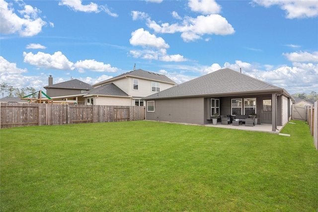 back of house with a lawn, a patio area, and an outdoor hangout area