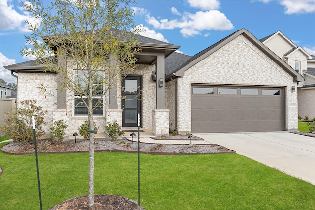 view of front of home featuring a front lawn and a garage