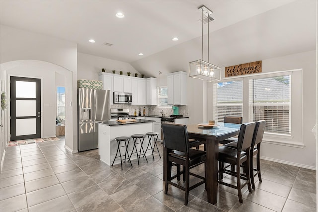 dining space with vaulted ceiling