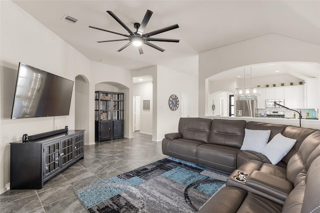 living room with ceiling fan and vaulted ceiling