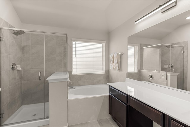 bathroom featuring tile patterned flooring, vanity, vaulted ceiling, and plus walk in shower